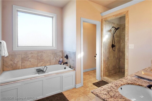 bathroom with tile patterned flooring, vanity, and shower with separate bathtub