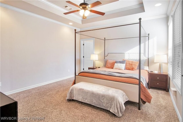 bedroom with a raised ceiling, ceiling fan, light colored carpet, and ornamental molding