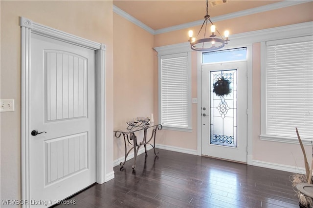 foyer featuring crown molding, dark hardwood / wood-style flooring, and a notable chandelier