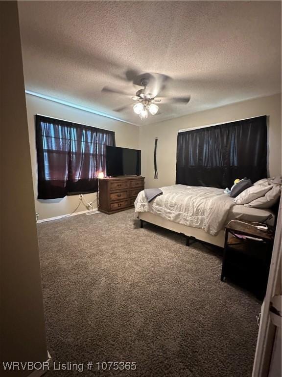 bedroom with ceiling fan, carpet, and a textured ceiling