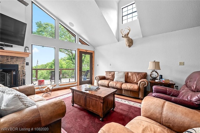 95147 S 4507th Rd, Vian, OK 74962 - living room with high vaulted ceiling, dark wood finished floors, a fireplace, and a textured wall