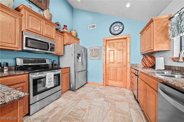 95147 S 4507th Rd, Vian, OK 74962 - kitchen with appliances with stainless steel finishes, dark stone countertops, high vaulted ceiling, recessed lighting, and light brown cabinetry