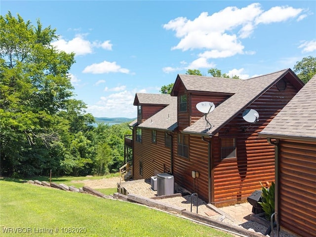 95147 S 4507th Rd, Vian, OK 74962 - view of side of property featuring a shingled roof, a yard, and log veneer siding