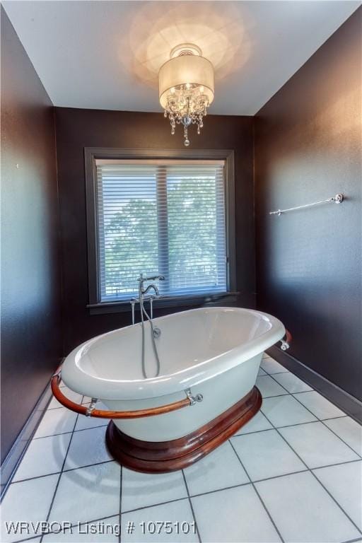 4001 Spring Mountain Rd, Fort Smith, AR 72916 - bathroom with tile patterned flooring, a bathtub, and a notable chandelier