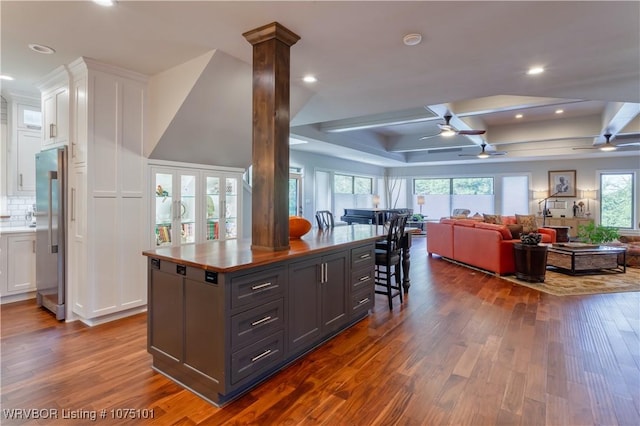 4001 Spring Mountain Rd, Fort Smith, AR 72916 - kitchen with a center island, coffered ceiling, dark hardwood / wood-style floors, ornate columns, and white cabinetry