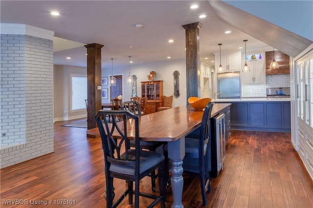4001 Spring Mountain Rd, Fort Smith, AR 72916 - dining area featuring decorative columns, wine cooler, and dark wood-type flooring
