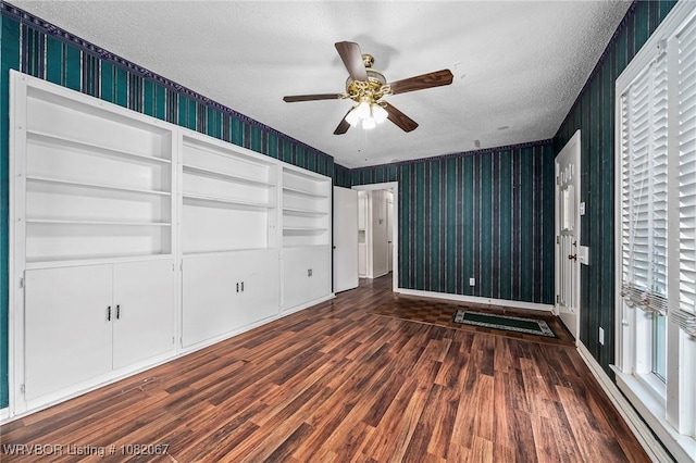 19 Hiland Dr, Fort Smith, AR 72901 - unfurnished bedroom with a textured ceiling, wood finished floors, wallpapered walls, multiple windows, and a ceiling fan