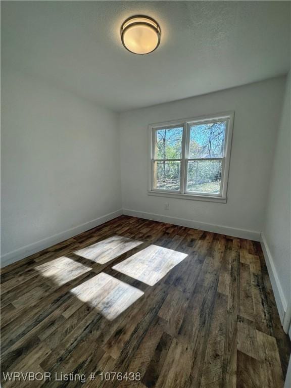 empty room featuring dark wood-type flooring