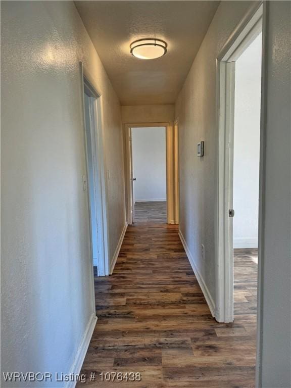 corridor with dark hardwood / wood-style floors