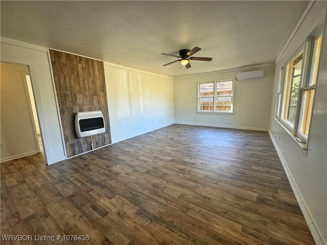 unfurnished living room featuring dark wood-type flooring, heating unit, a textured ceiling, an AC wall unit, and ceiling fan