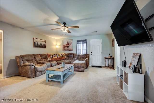 carpeted living room with ceiling fan