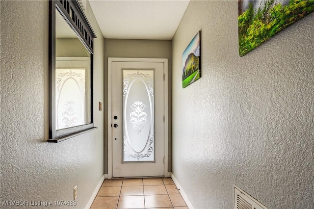 entryway with light tile patterned floors