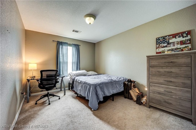 bedroom with carpet and a textured ceiling