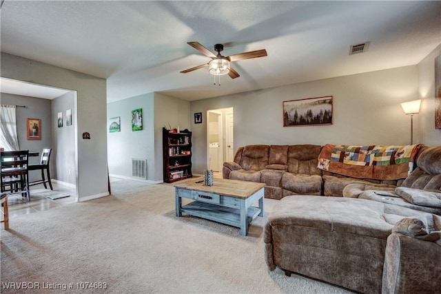 living room with ceiling fan and light colored carpet