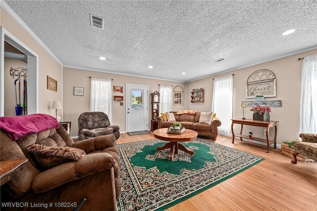 309 Neal Dr, Roland, OK 74954 - living area featuring ornamental molding, light wood-style floors, a textured ceiling, and recessed lighting