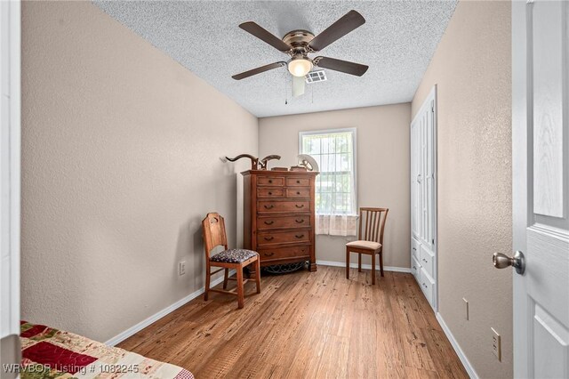 309 Neal Dr, Roland, OK 74954 - living area with wood finished floors, a textured ceiling, a textured wall, and ceiling fan