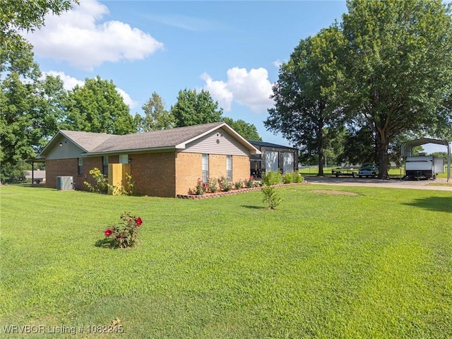 309 Neal Dr, Roland, OK 74954 - view of side of property with brick siding, a carport, and a lawn