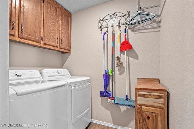 309 Neal Dr, Roland, OK 74954 - laundry room featuring washer and clothes dryer, cabinet space, and wood finished floors