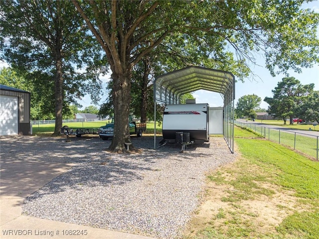309 Neal Dr, Roland, OK 74954 - view of parking featuring a carport and gravel driveway
