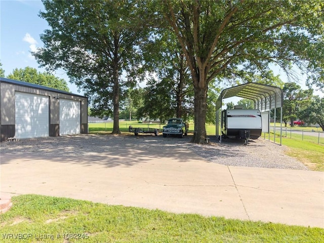 309 Neal Dr, Roland, OK 74954 - detached garage with driveway and a detached carport