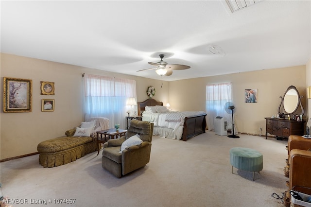 bedroom with ceiling fan and light carpet