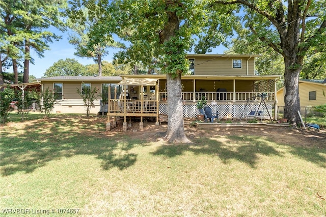 back of house with a lawn and a deck