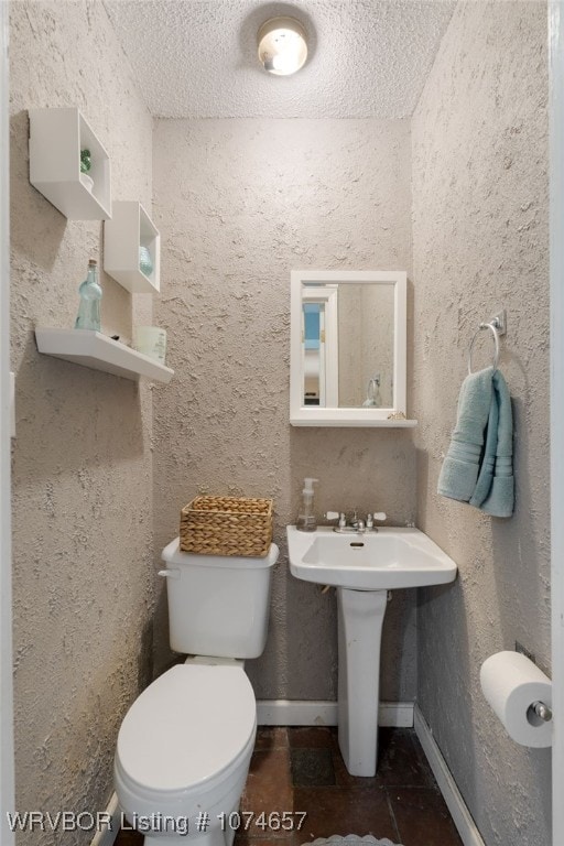 bathroom featuring sink and toilet