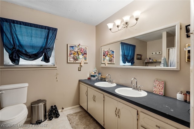 bathroom featuring tile patterned flooring, vanity, and toilet