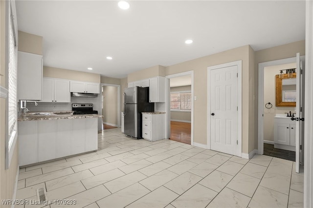 kitchen featuring white cabinets, under cabinet range hood, stainless steel appliances, and a sink