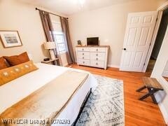 bedroom with wood finished floors