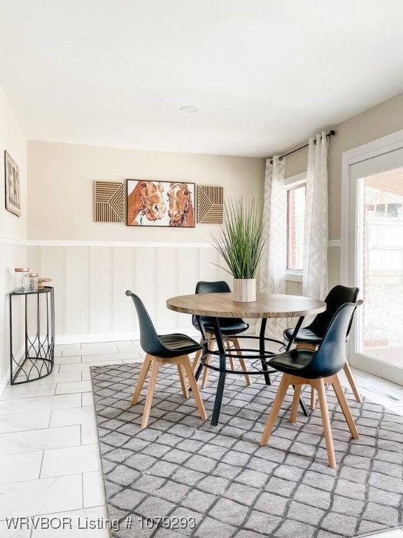 dining area featuring a decorative wall