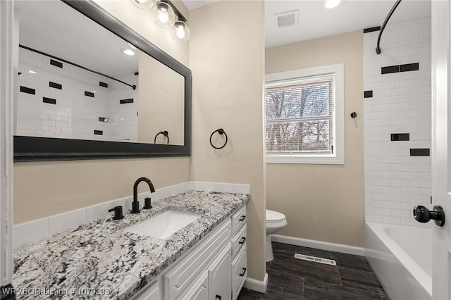 bathroom featuring toilet, baseboards, visible vents, and vanity