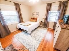 bedroom with wood finished floors and baseboards