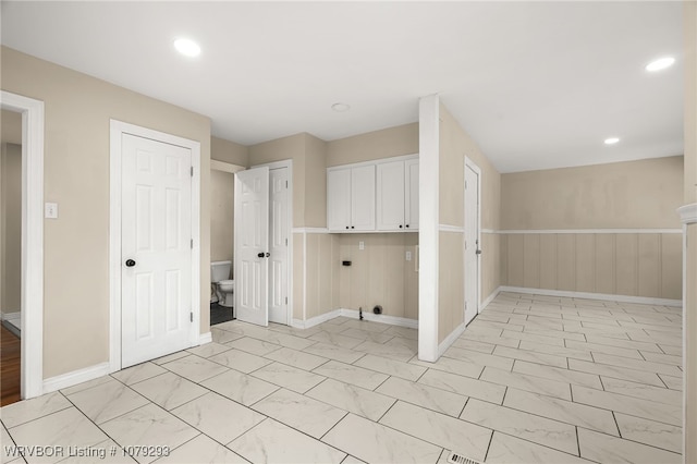 laundry area with baseboards, a wainscoted wall, electric dryer hookup, and recessed lighting