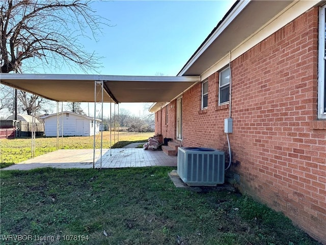 view of yard featuring central air condition unit and a patio