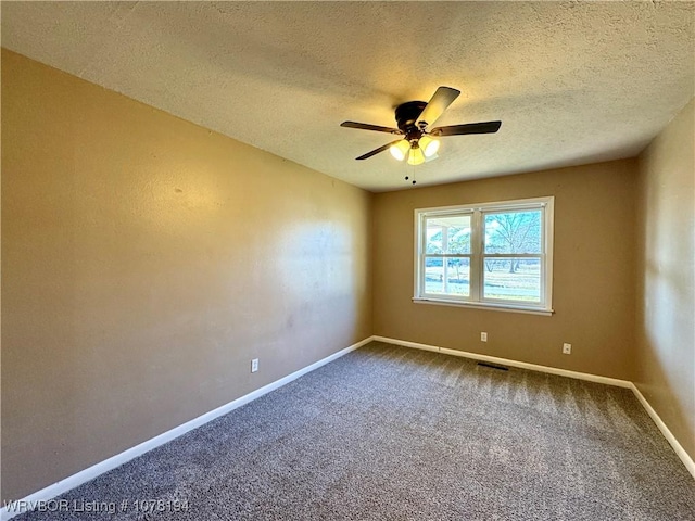 empty room featuring carpet flooring, ceiling fan, and a textured ceiling