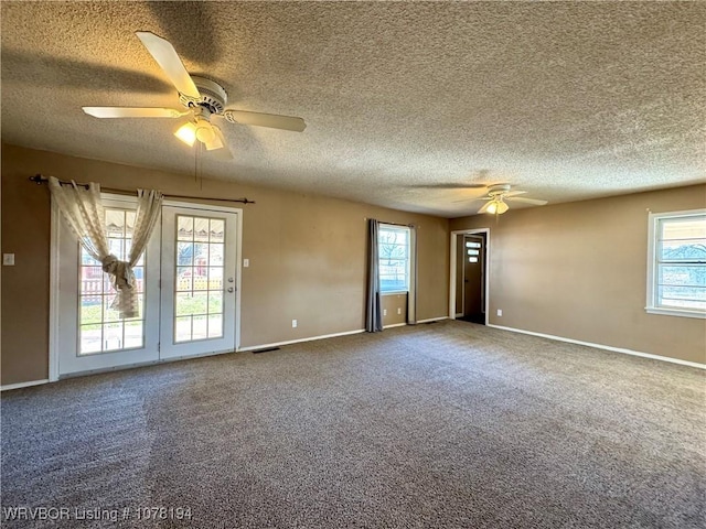 unfurnished room featuring carpet flooring, a textured ceiling, and ceiling fan