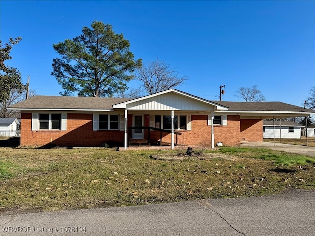 single story home featuring a front lawn and a carport