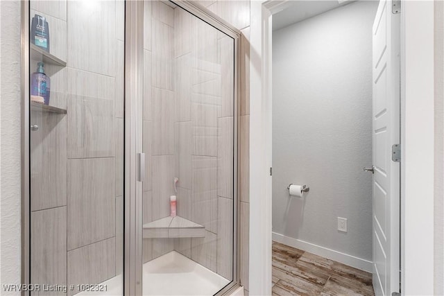 1228 Bradley St, Centerton, AR 72719 - full bathroom featuring a stall shower and wood finished floors