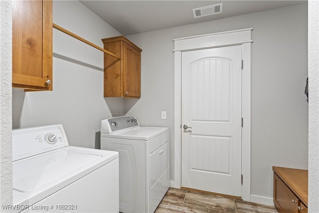 1228 Bradley St, Centerton, AR 72719 - washroom with washing machine and clothes dryer, cabinet space, and light wood-type flooring