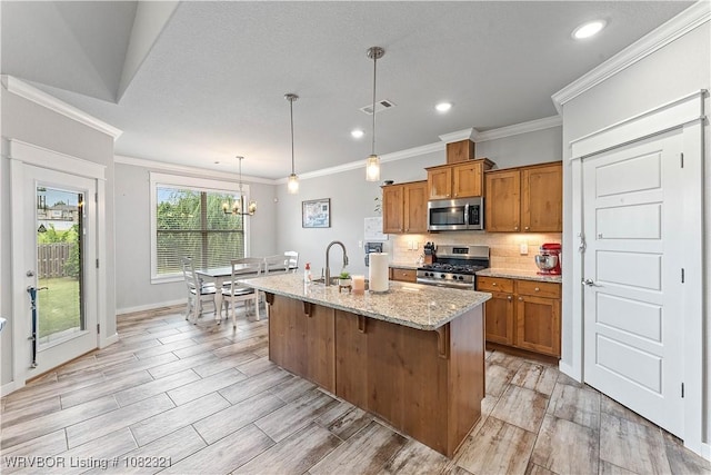 1228 Bradley St, Centerton, AR 72719 - kitchen with appliances with stainless steel finishes, brown cabinetry, crown molding, backsplash, and light stone countertops