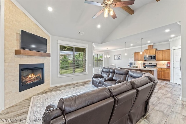1228 Bradley St, Centerton, AR 72719 - living area featuring lofted ceiling, recessed lighting, ceiling fan, a fireplace, and ornamental molding
