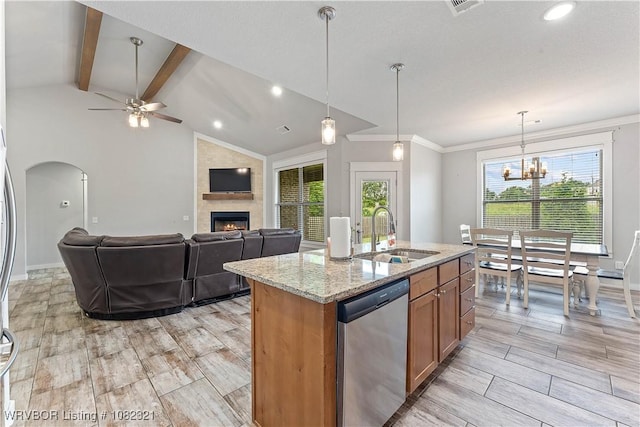 1228 Bradley St, Centerton, AR 72719 - kitchen featuring stainless steel dishwasher, a fireplace, brown cabinets, ceiling fan, and light stone counters
