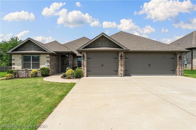 1228 Bradley St, Centerton, AR 72719 - view of front of house featuring an attached garage, concrete driveway, a front lawn, and brick siding