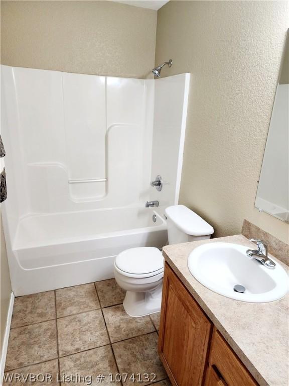 full bathroom with tile patterned flooring, vanity, shower / bathtub combination, and toilet