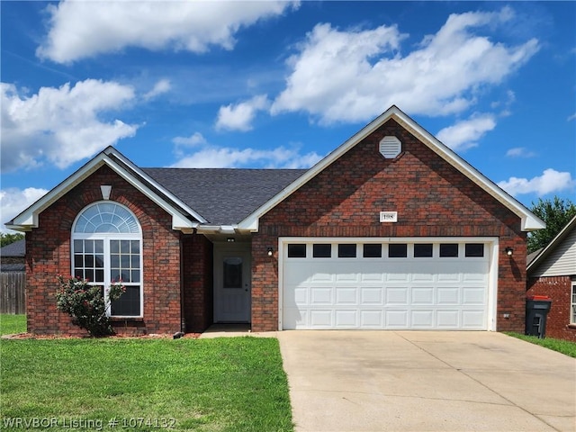 view of front of property with a garage and a front lawn