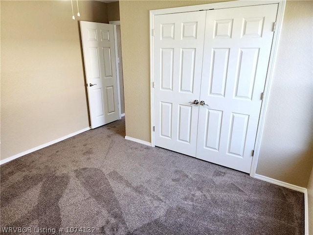 unfurnished bedroom with carpet flooring and a closet