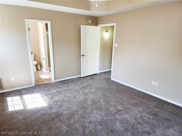 unfurnished bedroom with light carpet and ensuite bath