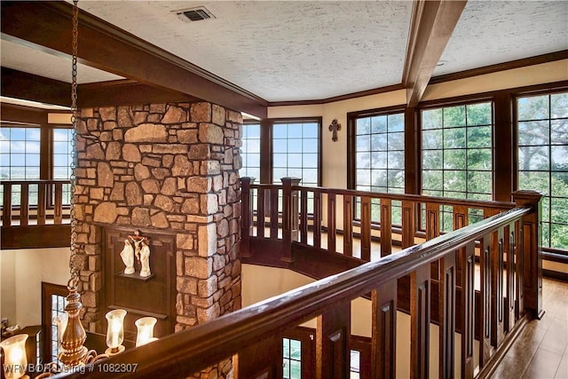 3417 Royal Scots Way, Fort Smith, AR 72908 - hall featuring wood finished floors, a textured ceiling, healthy amount of natural light, an upstairs landing, and crown molding