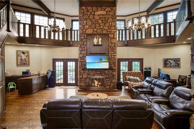 3417 Royal Scots Way, Fort Smith, AR 72908 - living room featuring a chandelier, french doors, a high ceiling, crown molding, and a stone fireplace